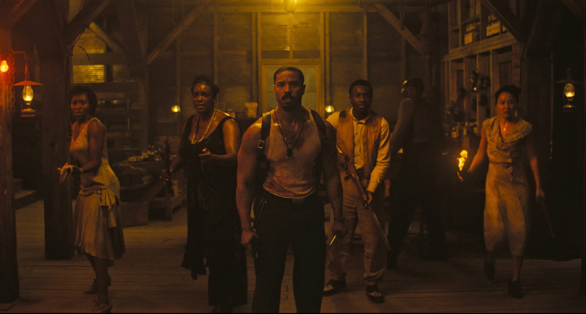 A shot from Sinners of the cast facing the camera, all armed, waiting for an attack.