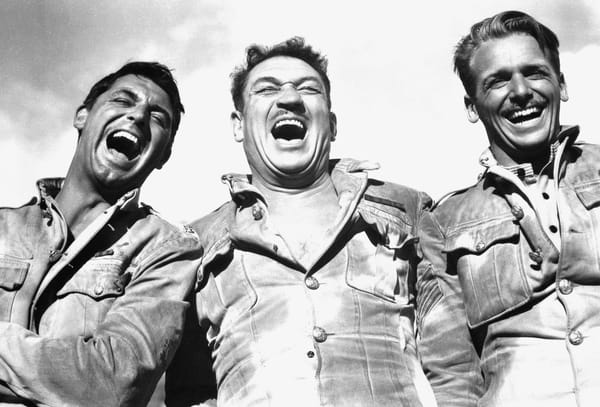 A screenshot from Gunga Din of three men laughing.