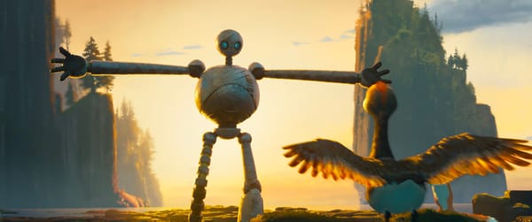 A shot from The Wild Robot with the main character stretching out its robot arms as a young goose watches and stretches out its own wings.
