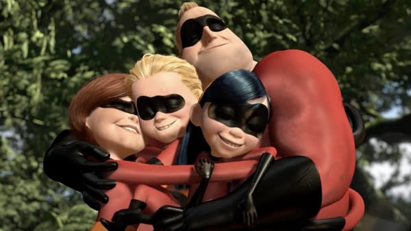 A screenshot of The Incredibles, with the full family hugging, jungle trees in the background.