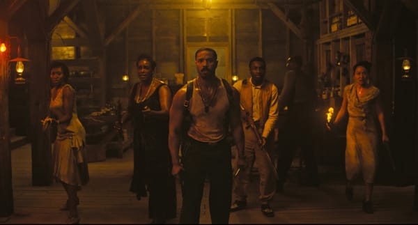 A shot from Sinners of the cast facing the camera, all armed, waiting for an attack.